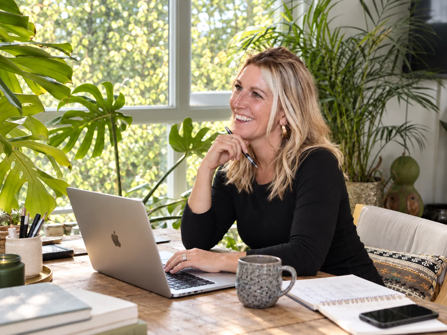 Indigo Fox founder in a bright, plant-filled home workspace