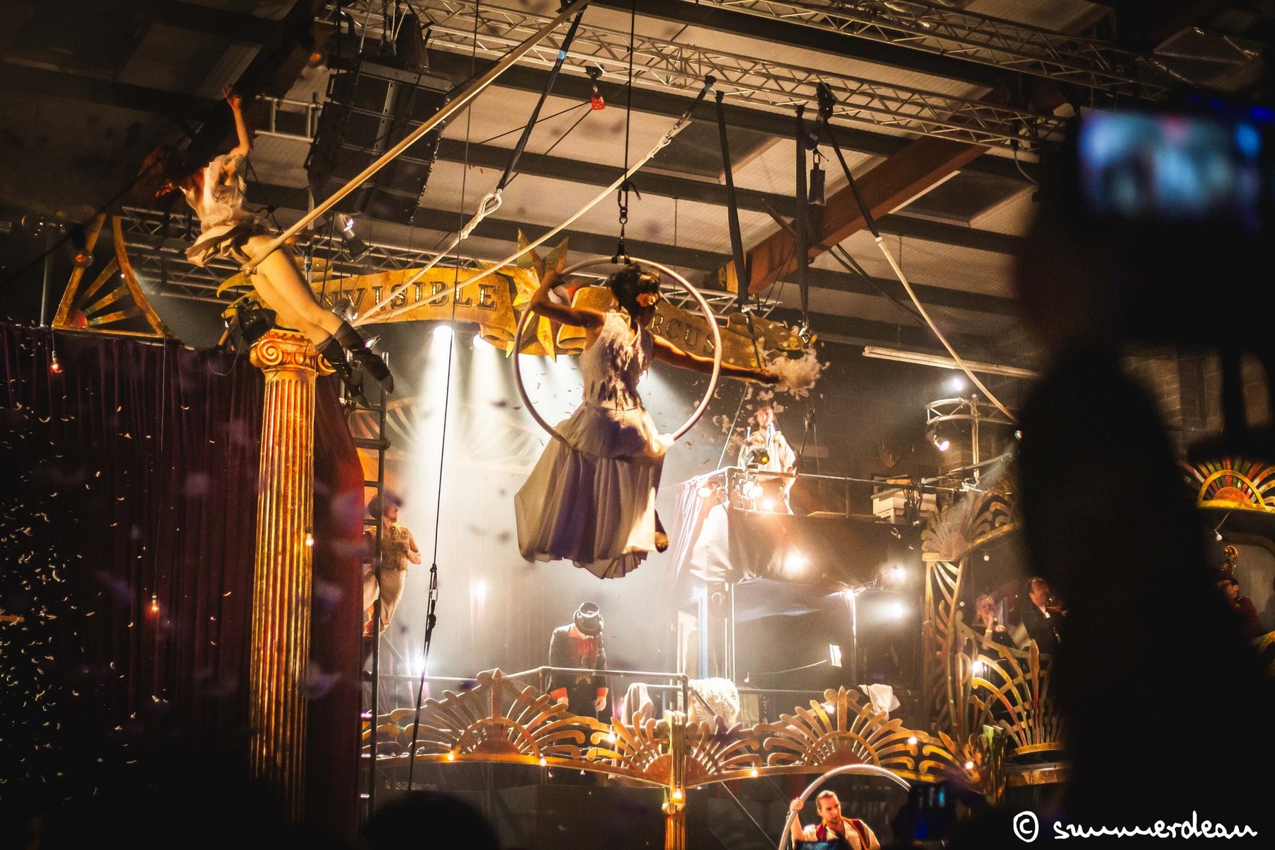 Aerial artist performing within a creative live event production